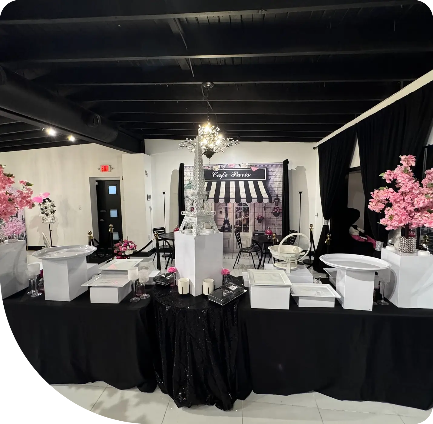 task15 (1) A room with tables and chairs covered in black cloth.